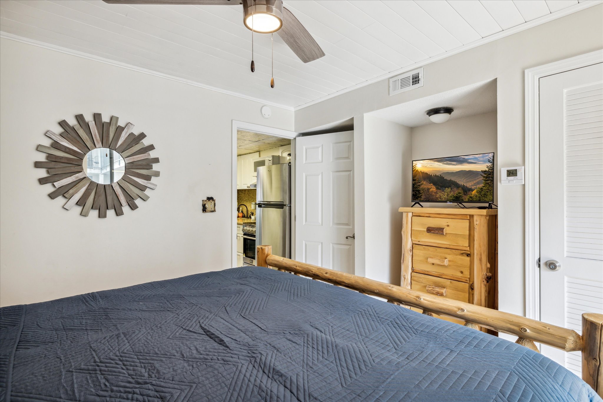 King bedroom with flat screen tv and dresser for clothing storage