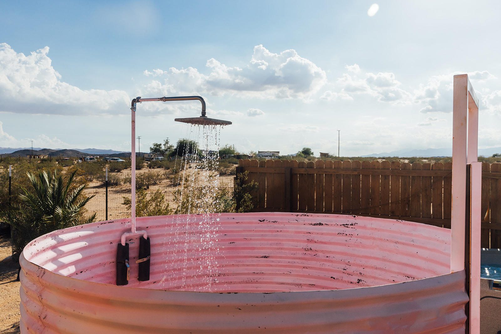 Close-up of the unique outdoor pink shower, blending playful design with desert adventure.