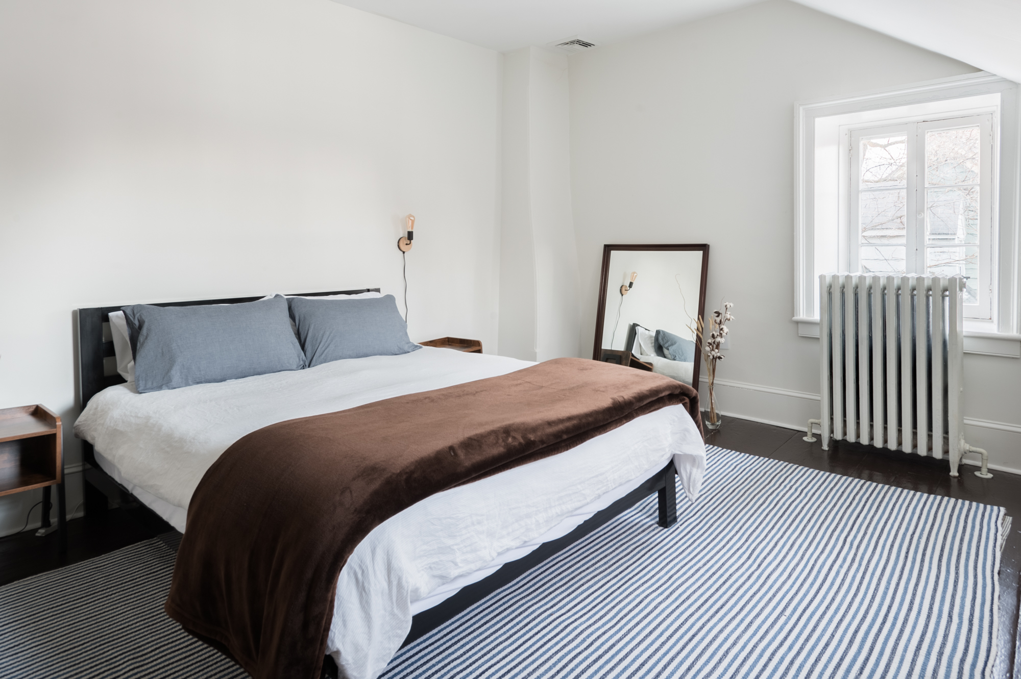 The queen bed in Bedroom 1