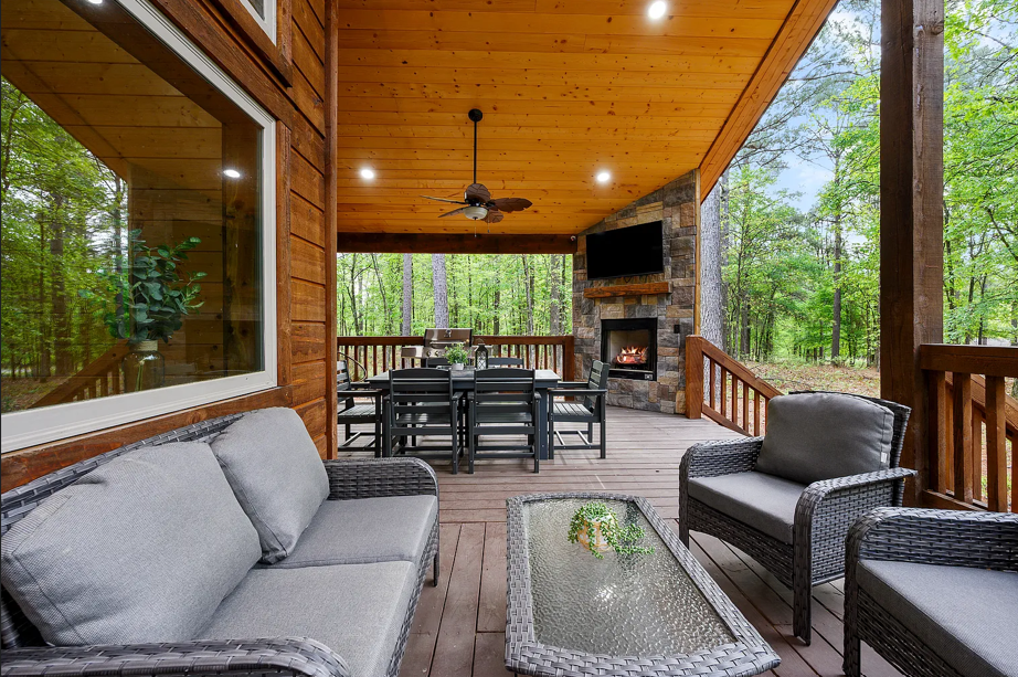 Covered outdoor lounge with comfortable seating and peaceful forest surroundings