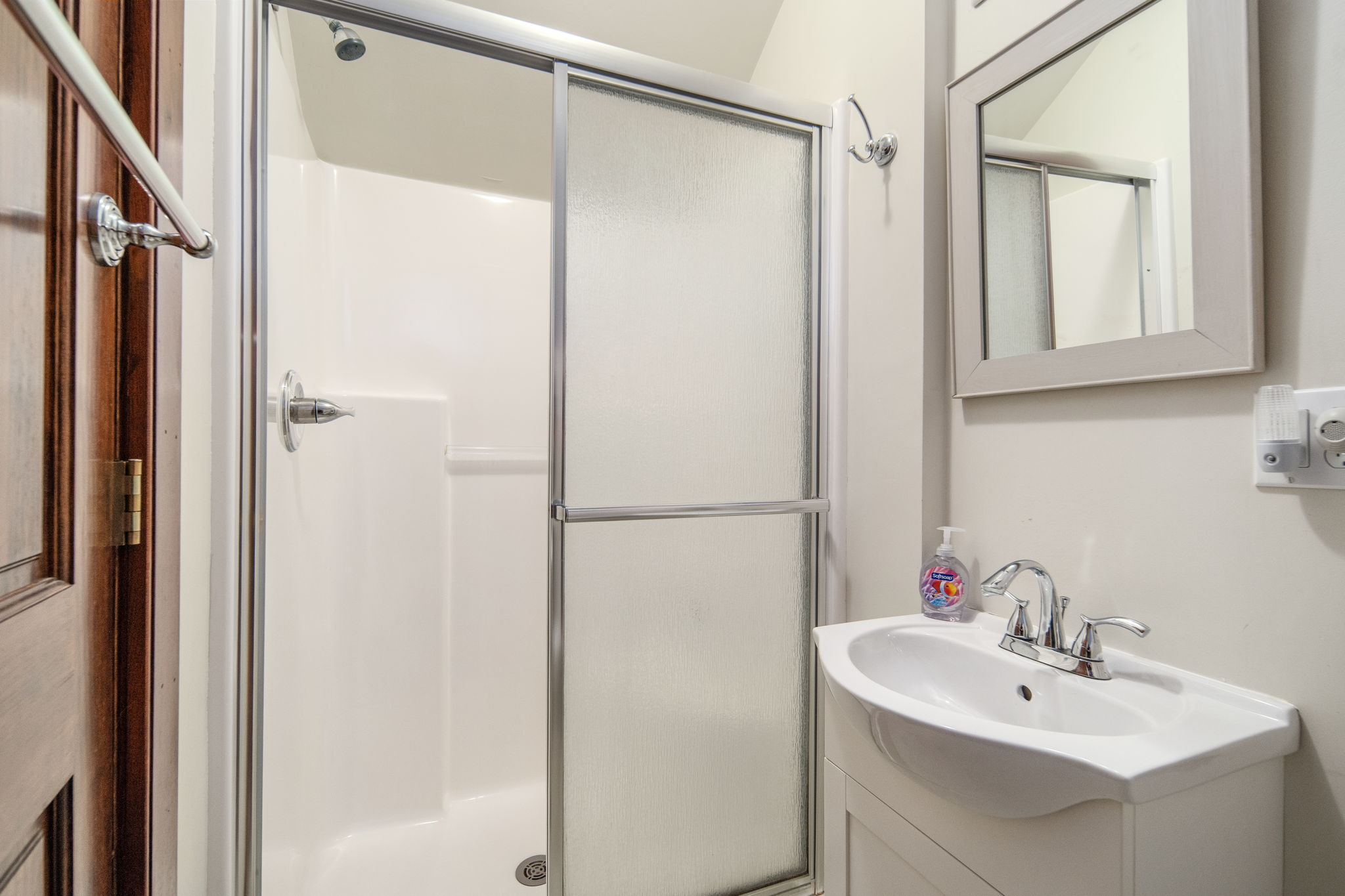 A glass-enclosed shower completes the upstairs bathroom.
