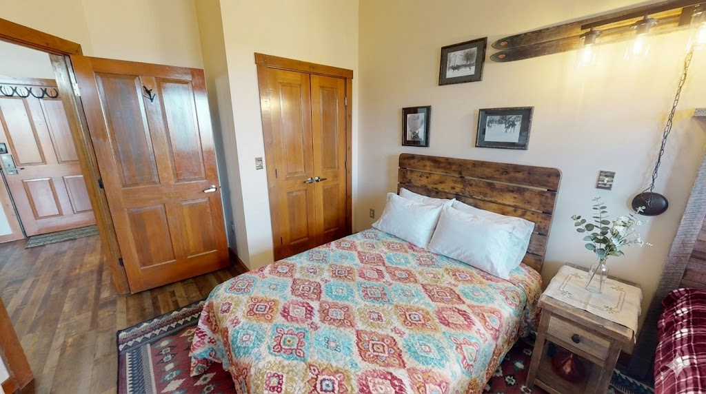 Wake up to sunlight over the mountain from this charming ski lodge-style bedroom.