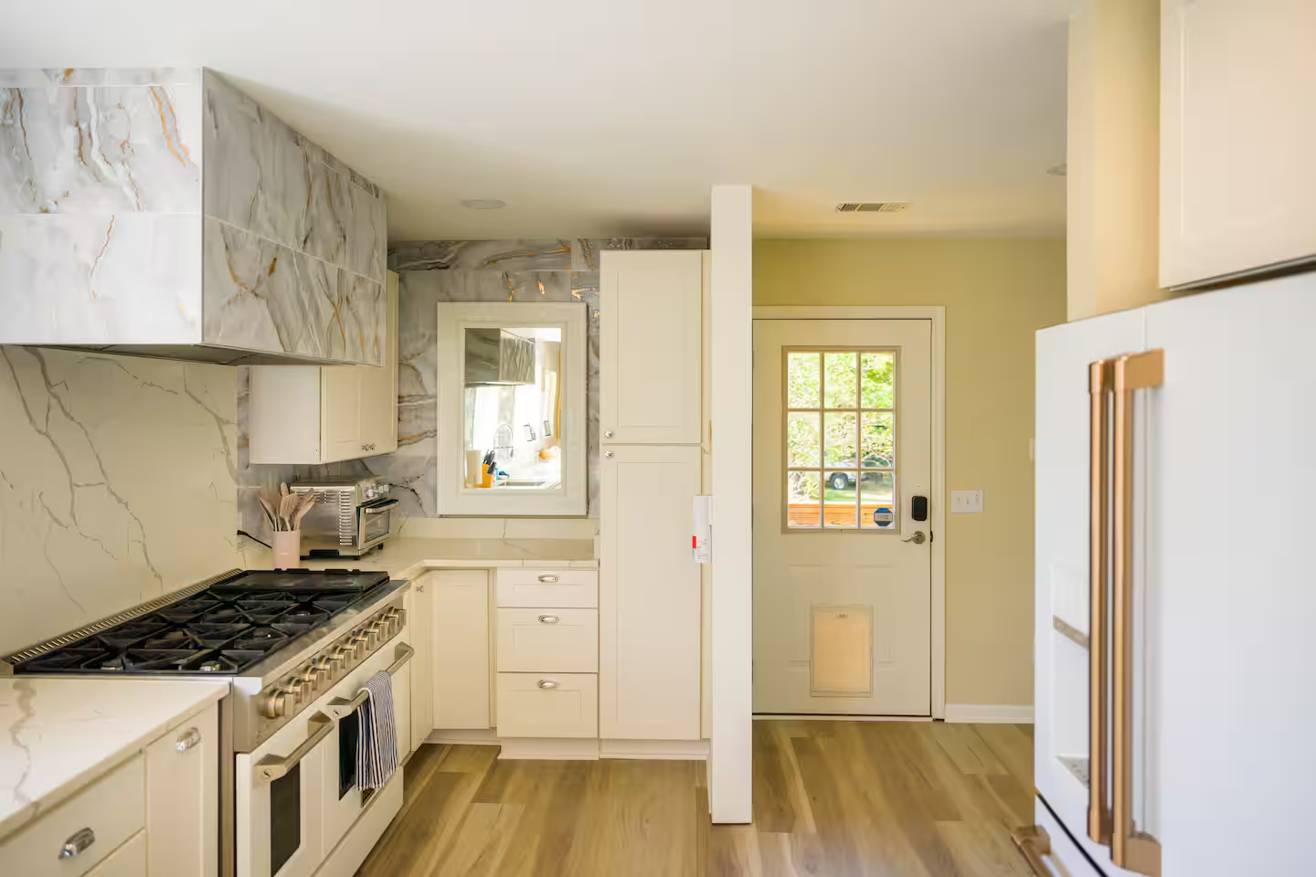 Whether you're stepping in with groceries or stepping out for coffee on the deck, this kitchen has you covered.