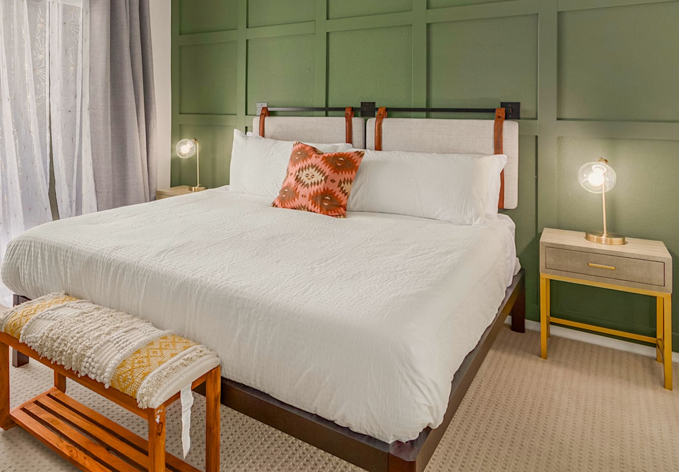 Spacious bedroom with king bed, workspace, and simple storage for short or extended stays.