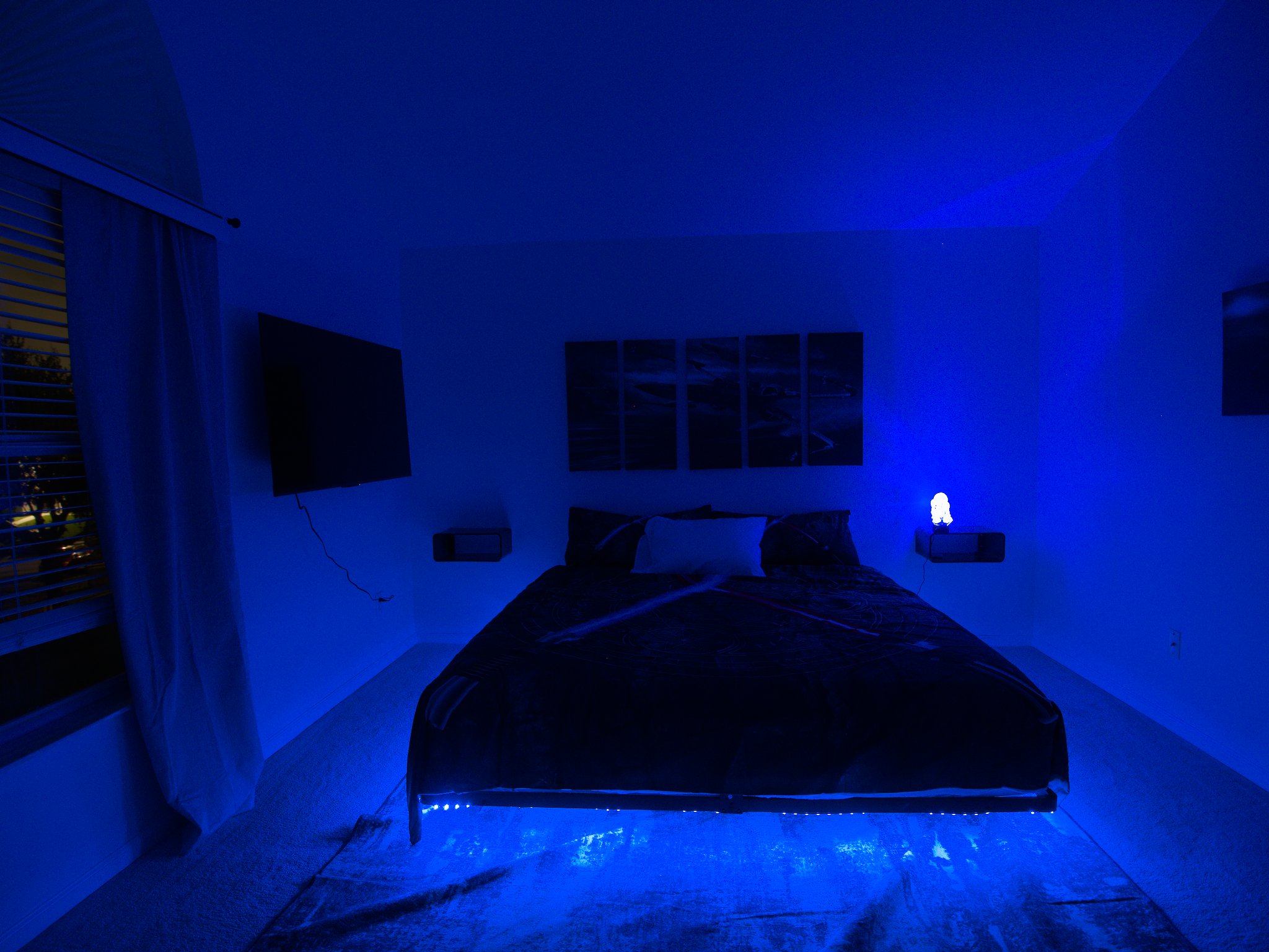 Star Wars room with king bed, LED lights, and R2D2 projection. 