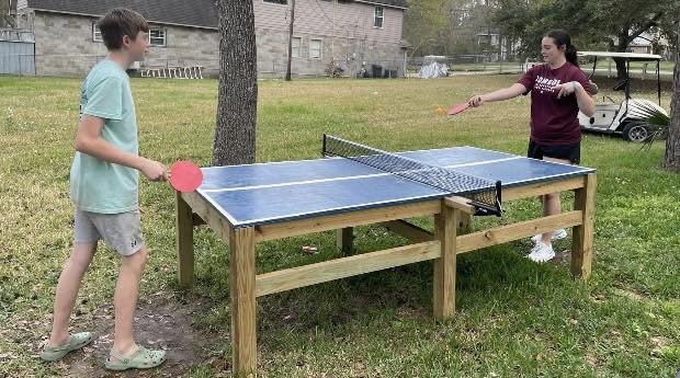 Cousins enjoying a cut-throat game of ping pong!