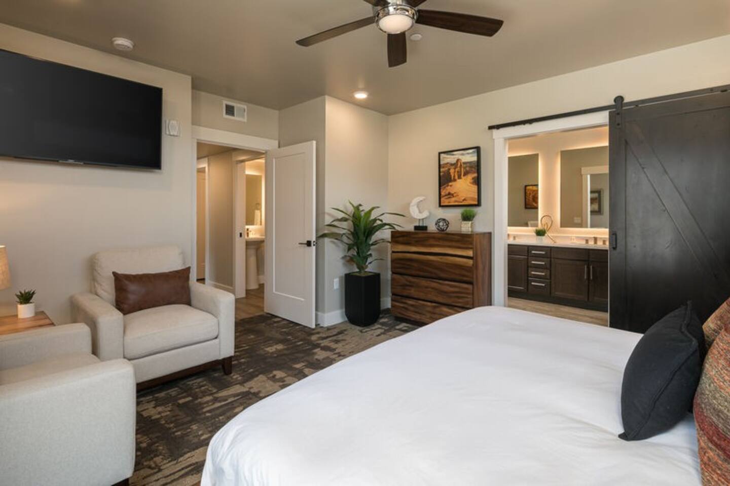 You'll love waking up in the beautiful master bedroom, which provides a 55" TV, stylish sliding barn doors, and a comfortable king bed.