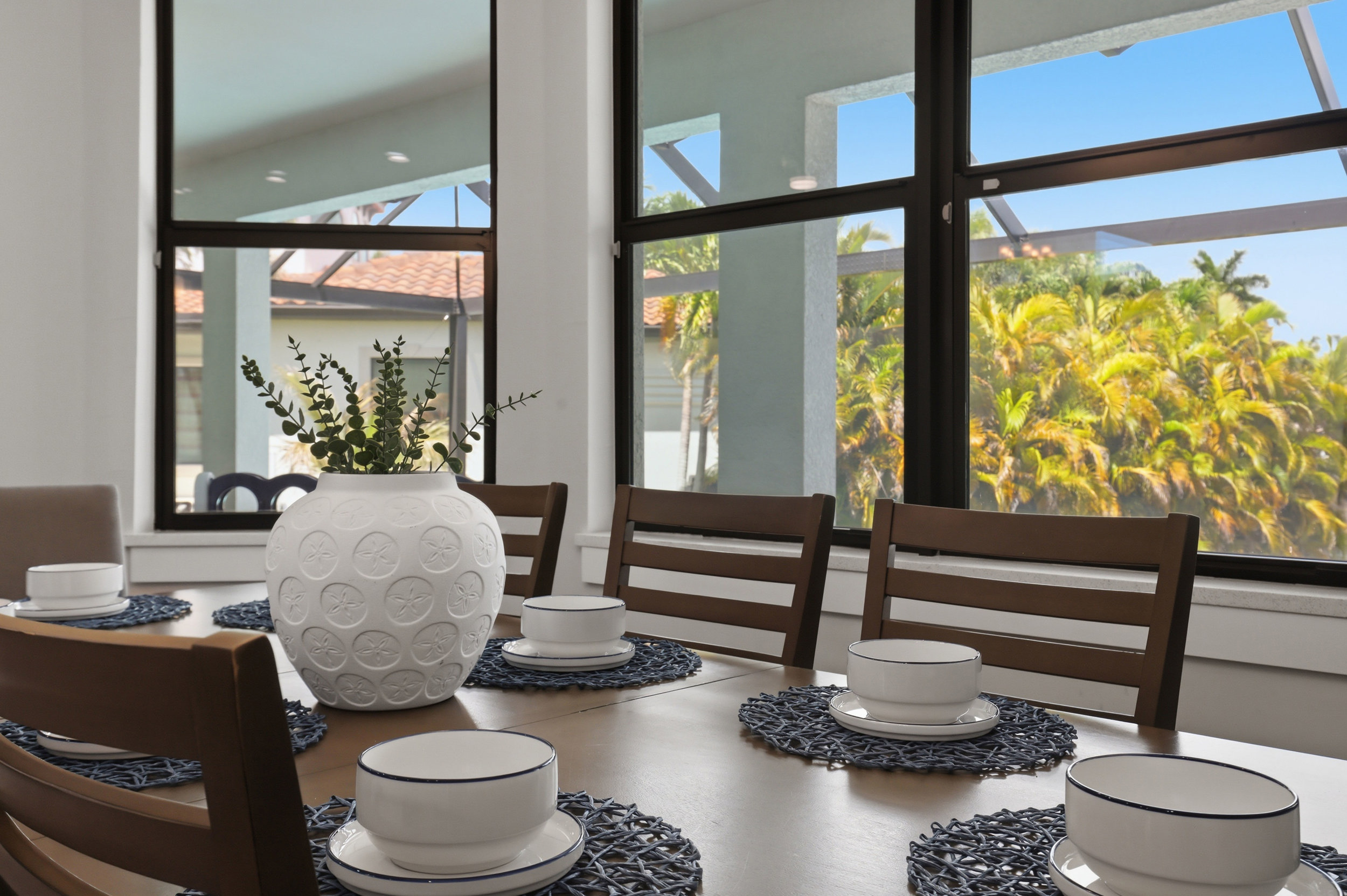 8 Man table plus 6 barstools at the breakfast bar located inside