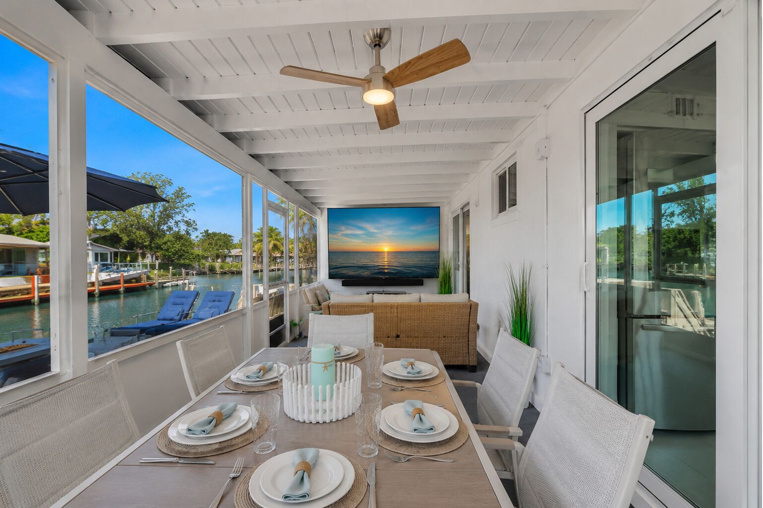 Waterfront dining with seating for six, plus a built-in extension leaf to accommodate up to 10 guests, canal views, and a 65” TV.