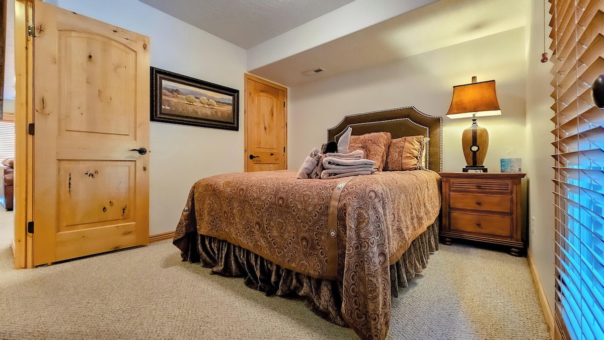 The second bedroom is outfitted with a queen bed, luxurious linens, and plush pillows.
