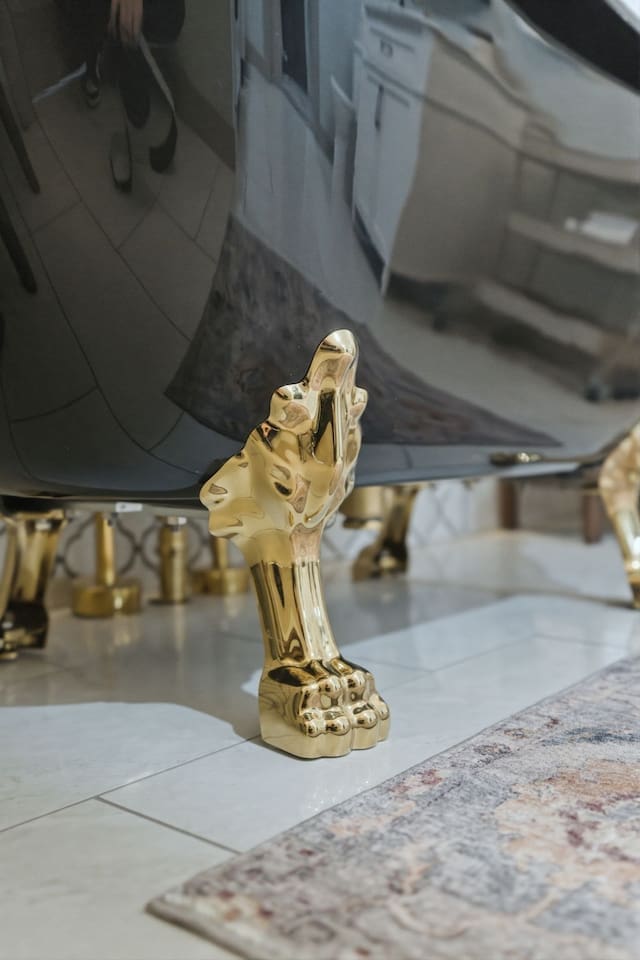 Elegant gold clawfoot detailing adds a touch of classic luxury and timeless charm to the space
