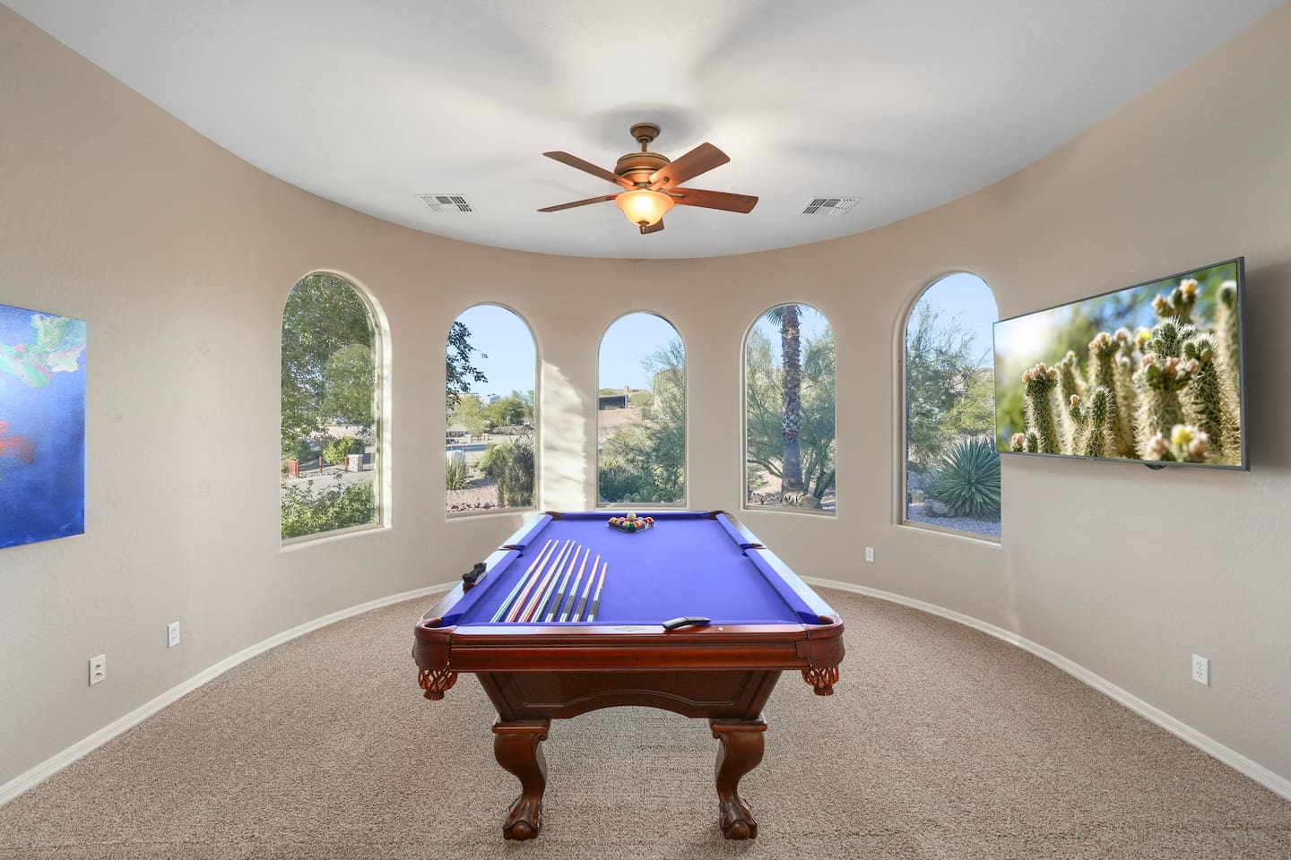 Bright, open layout with curved walls and arched windows that flood the room with natural light.