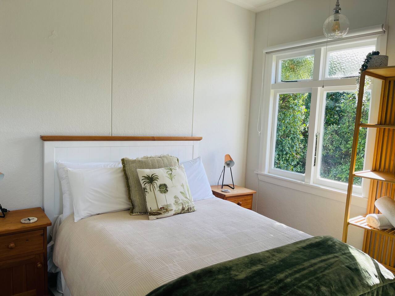 Bedroom 2 has a generous double bed with a nice comfy mattress topper, bedside table lamps for that cozy bedtime read, an eco heater to keep you nice and warm in winter and a soothing bush clad view.