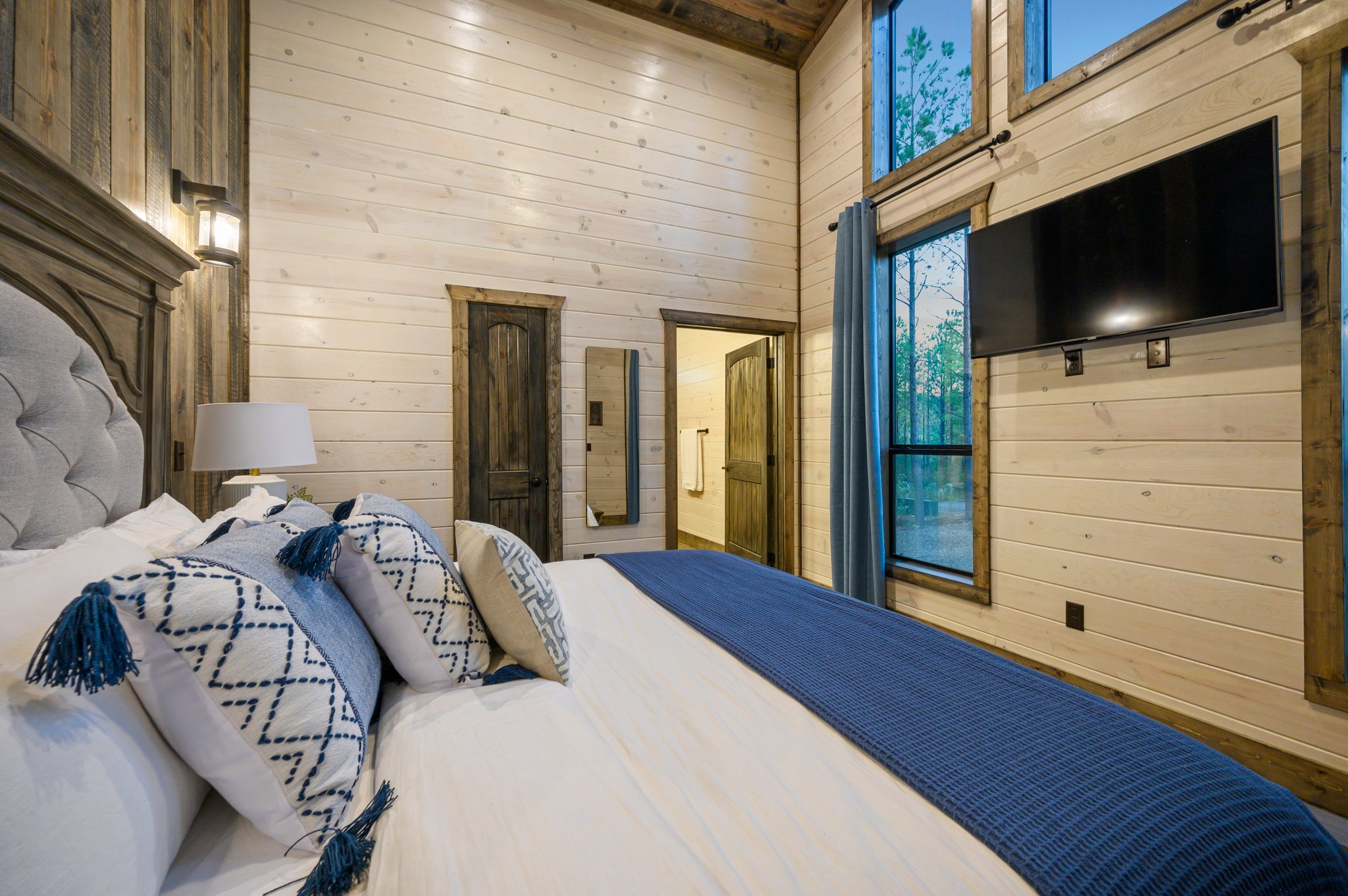 Sweet dreams await in this designer bedroom with warm, reclaimed wood walls.