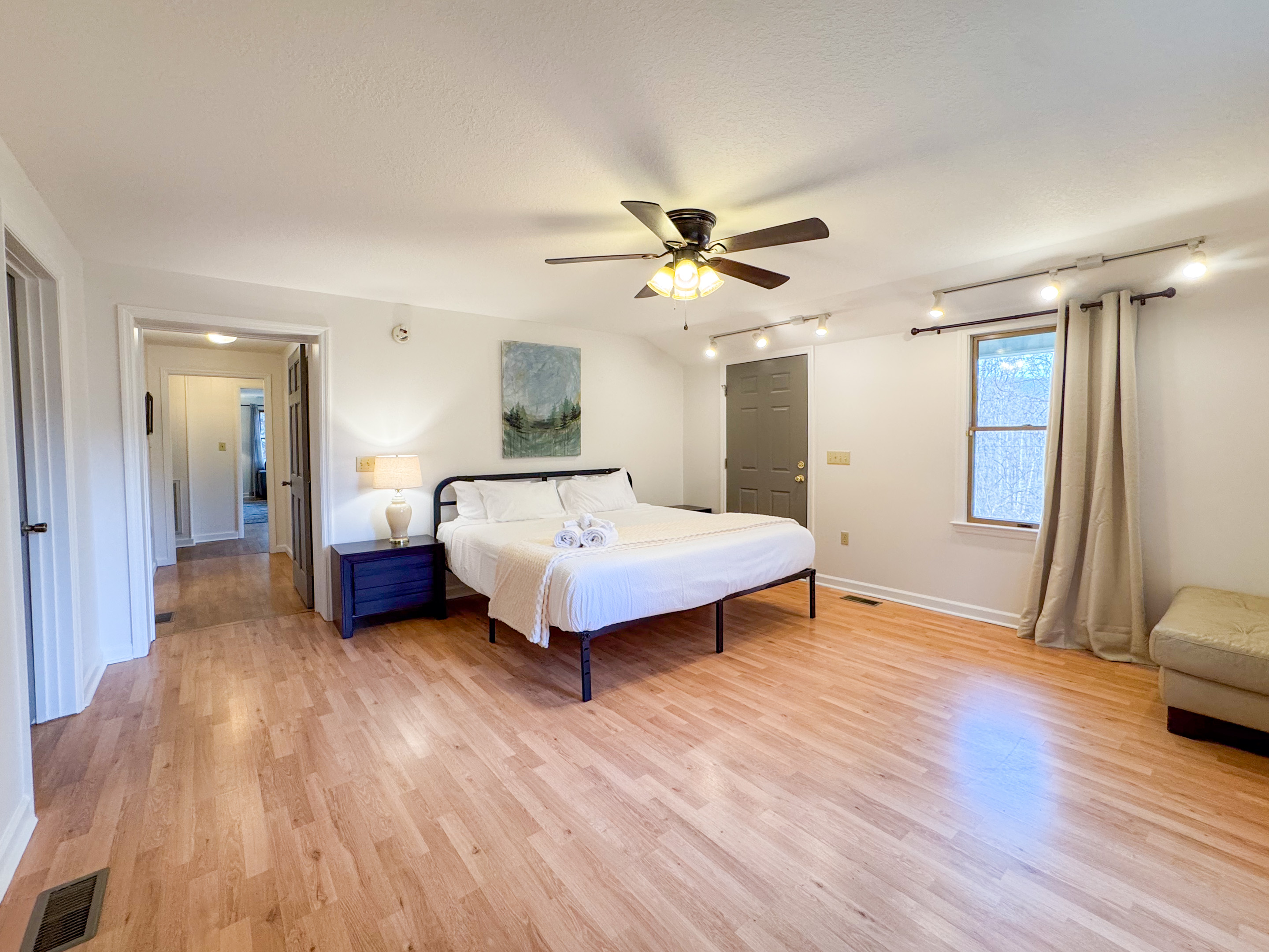 The master bedroom features a king size bed, large space, closet, and ensuite bathroom with accessibility features.