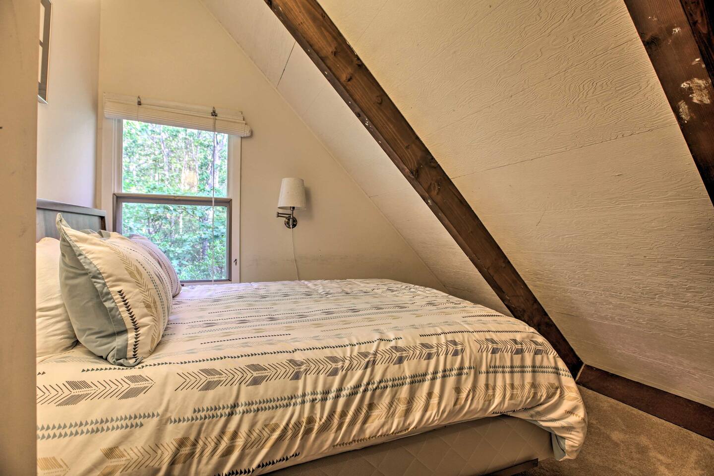Wind down with reading a new novel in this cozy queen bed.
