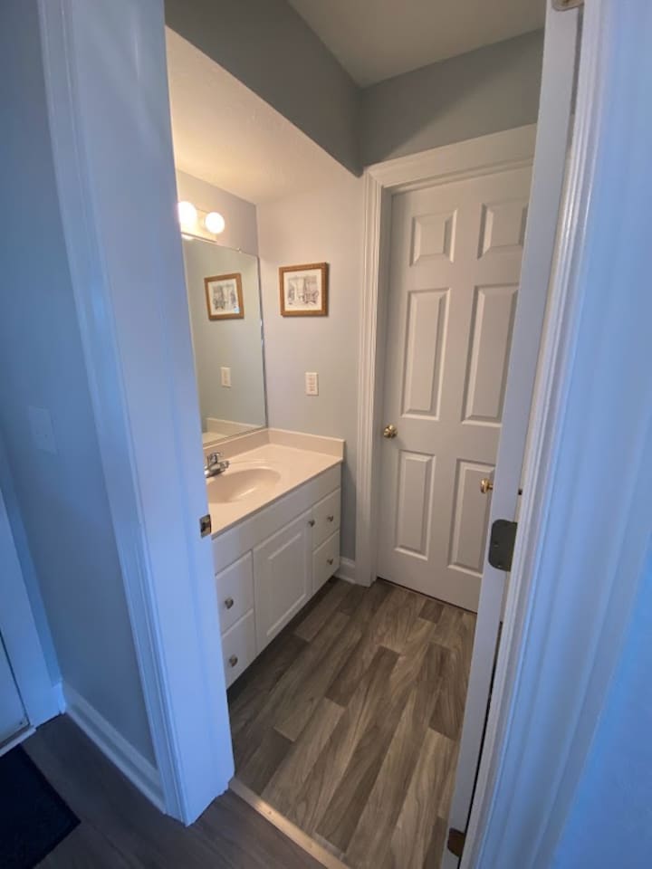 1st floor half bath and door that leads outside to the private pool, hot tub and tiki bar.