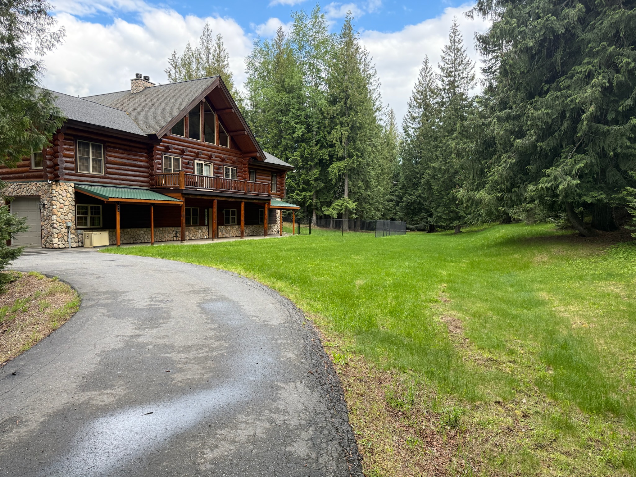 Drive up to cabin, arrive at back of cabin with view of large private lawn