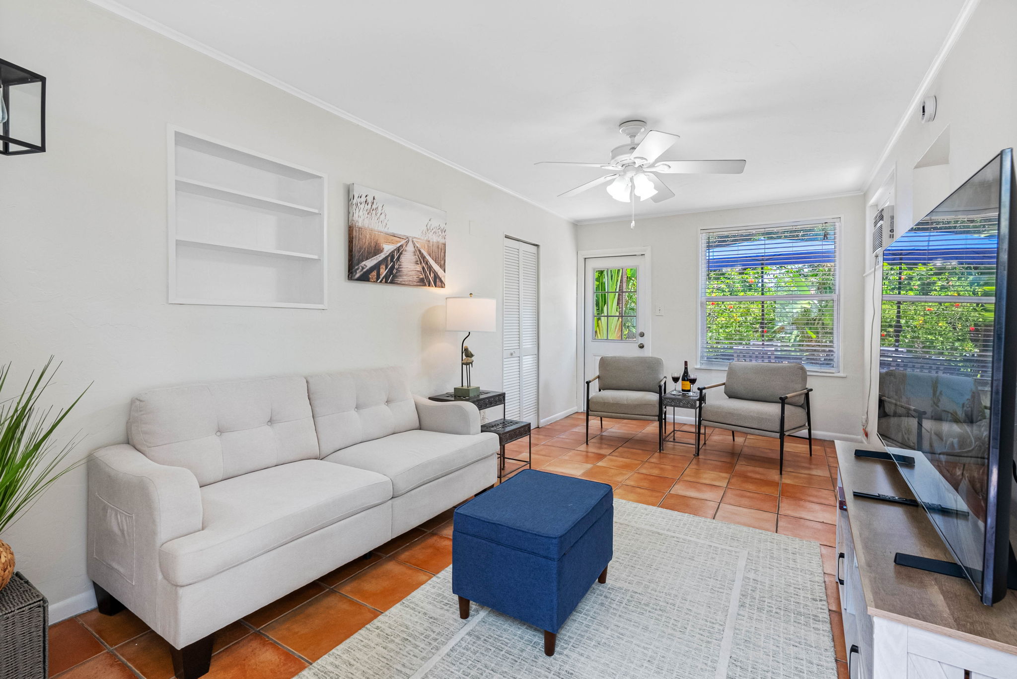 This stylish bonus living room adds flexibility and flow, offering guests an additional place to relax, socialize, or take in the natural light from the surrounding windows.