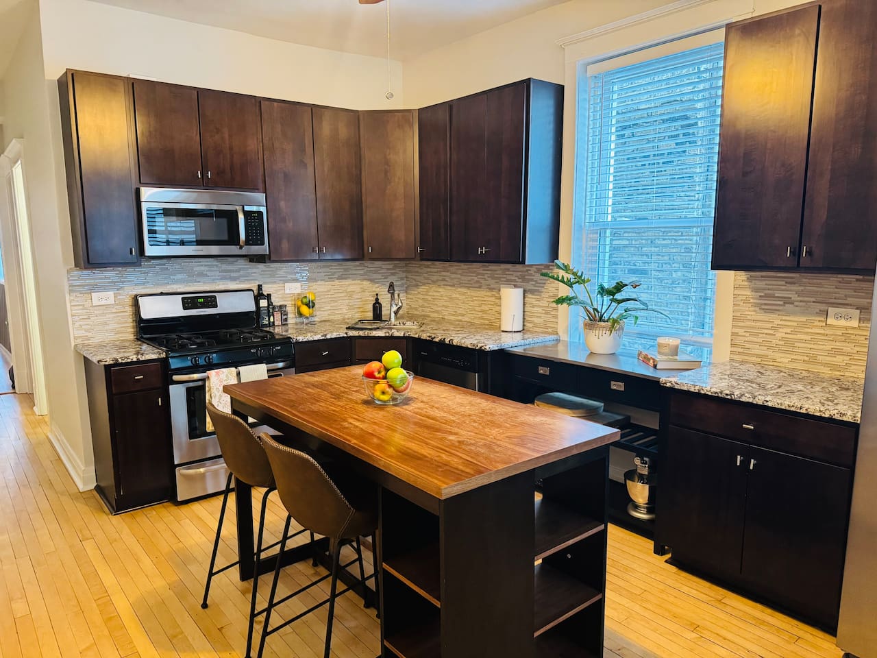 Fully stocked kitchen with large island and modern appliances.