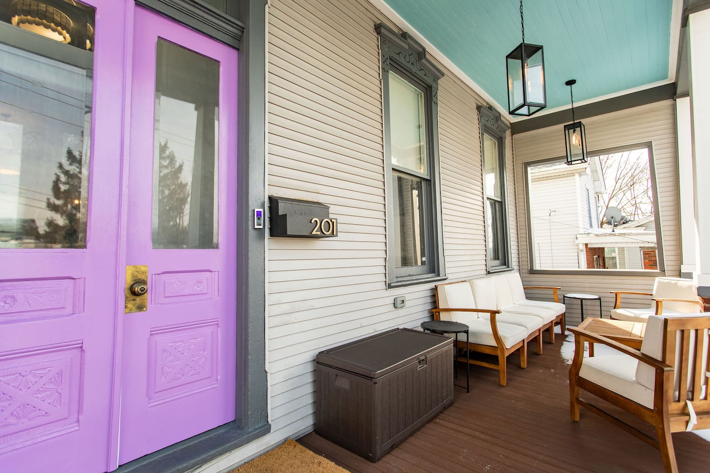 A charming front patio with welcoming outdoor seating, leading up to the entrance door, creating a warm and inviting first impression of the home.