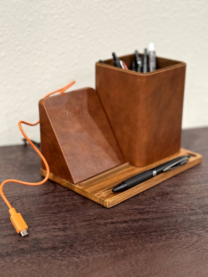 Charging station includes contact charging as well as two USB ports in the back and a pencil/pen holder.
