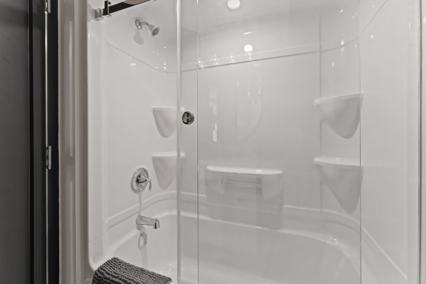 Frameless glass shower doors emphasize openness.