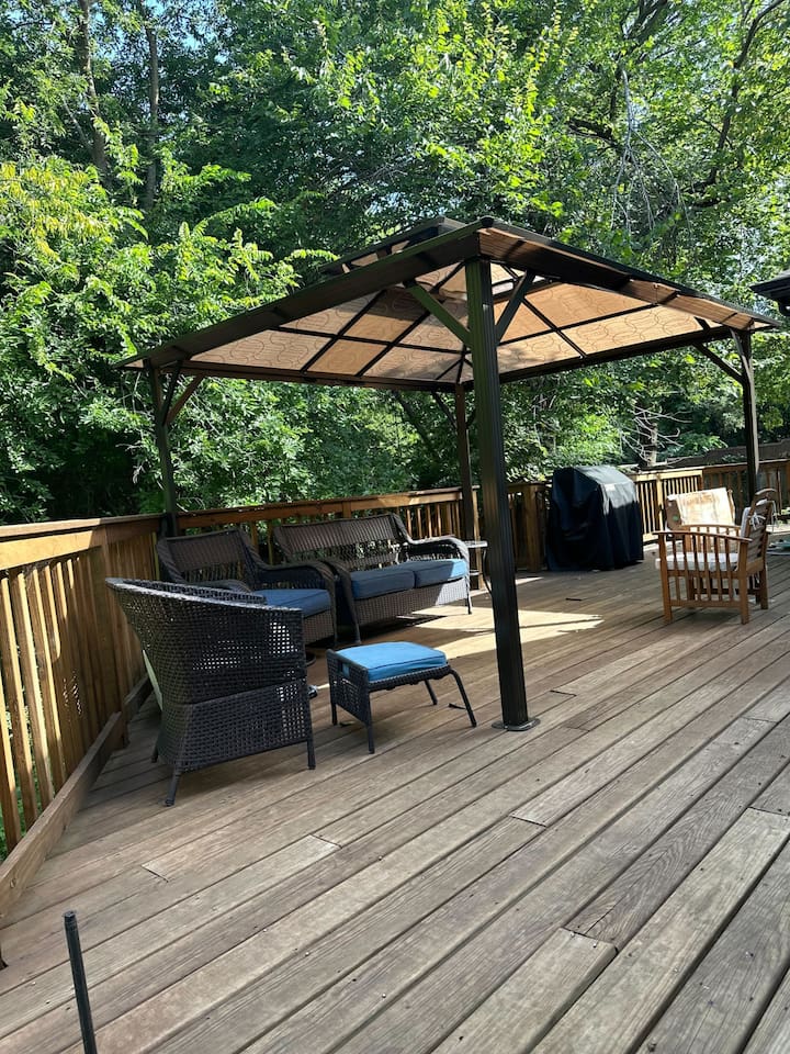 Covered patio with grill for outdoor dining and entertaining.