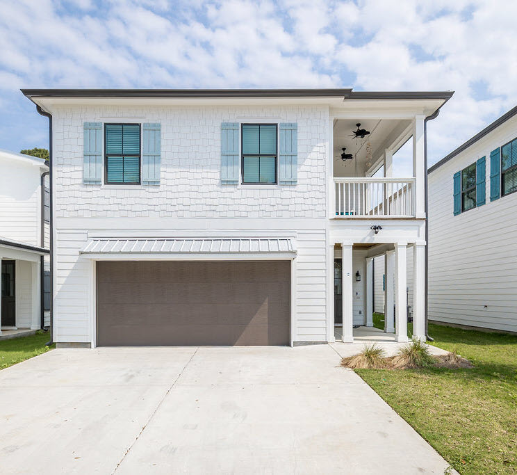 Beautiful White Exterior with Blue Window Panels Exude Both Coastal and Modern Vibes