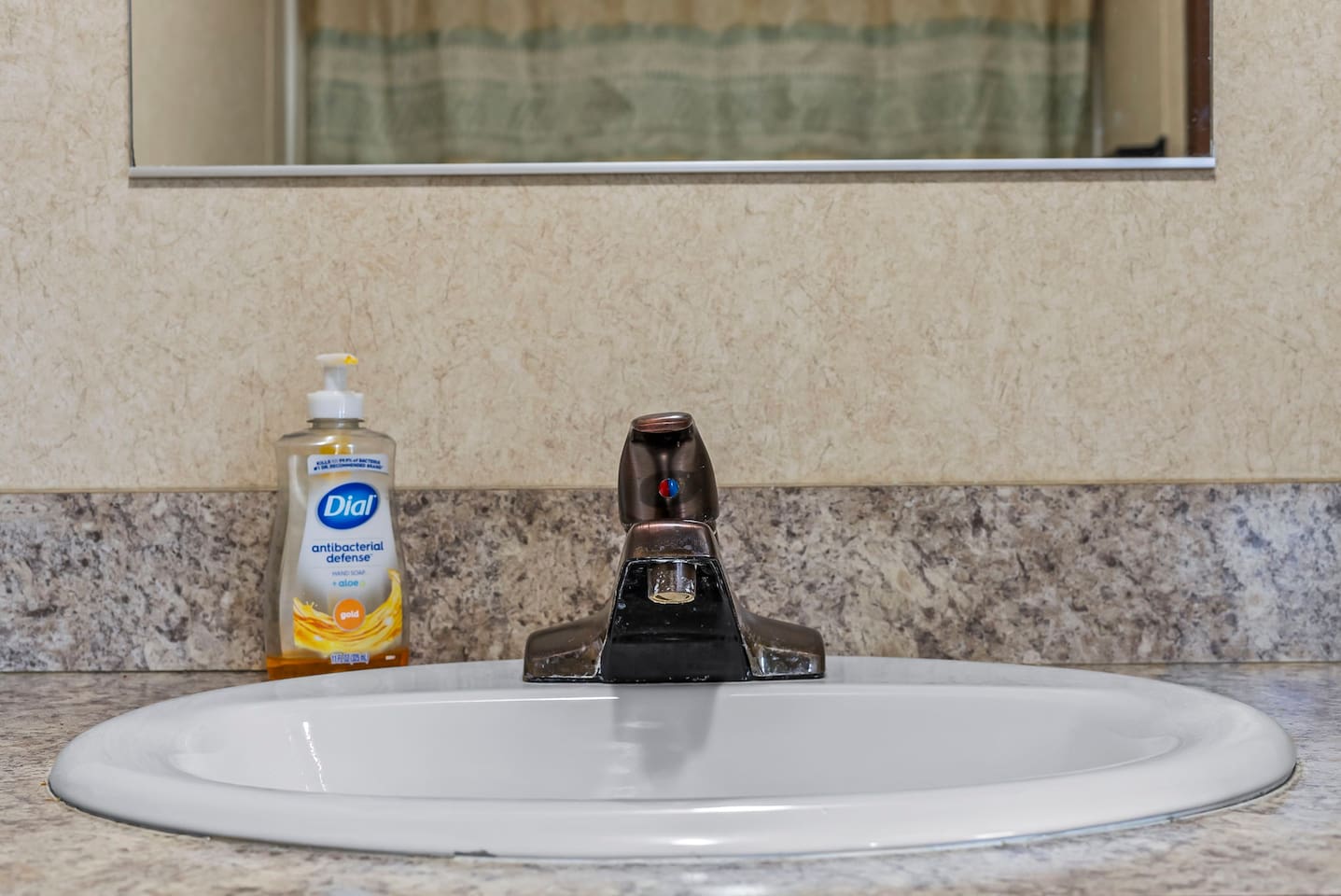 Bright vanity area with a wide mirror and well-lit sink—perfect for getting ready with ease.