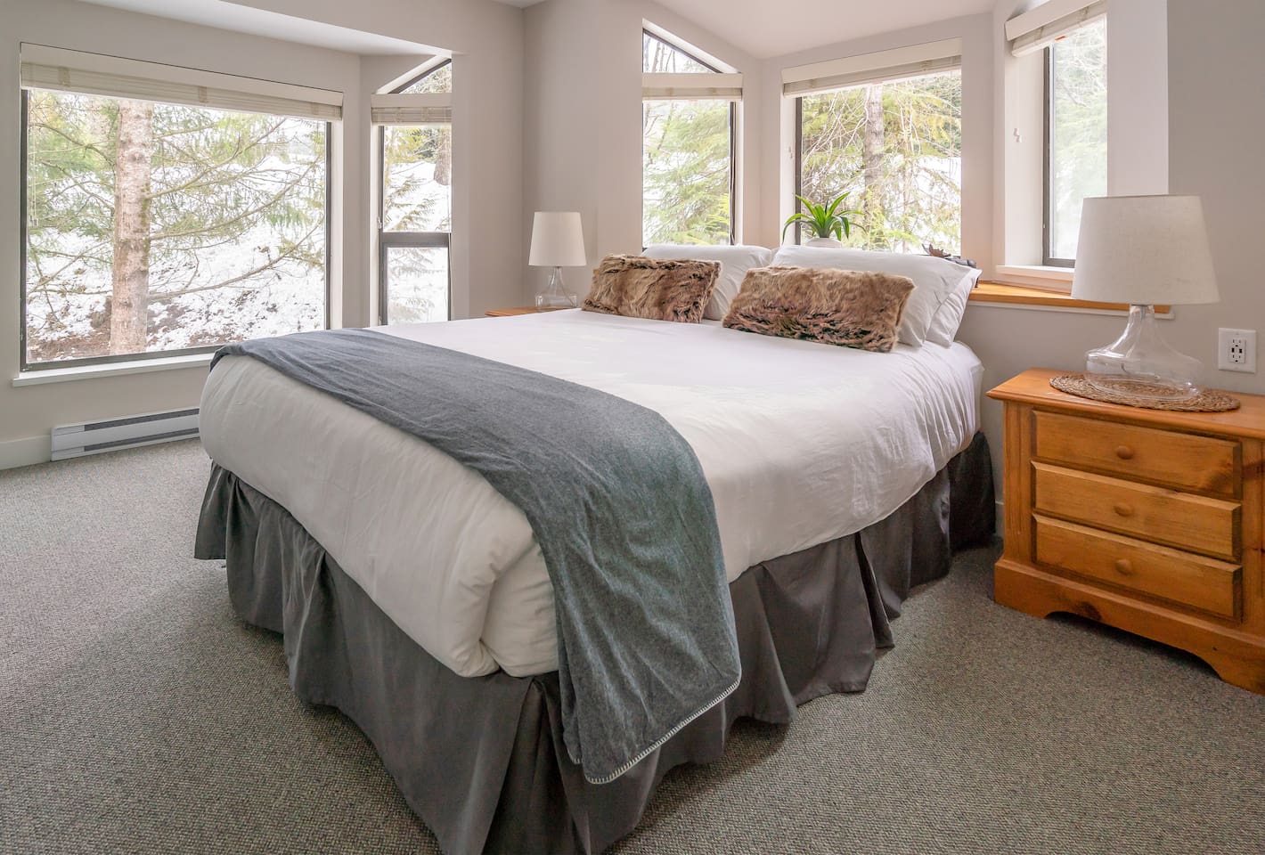 Bedroom#1's proximity to the surrounding mountains is accentuated by large windows that frame 2 walls.  Luxurious Queen bed, integrated closet system w/ motion-activated light, HD TV & elevated USB Type C & A wall outlets complete this room. 