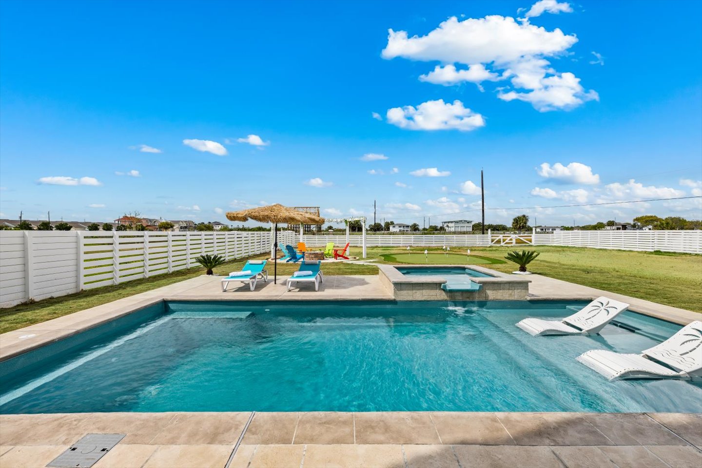 Relax and unwind in the backyard oasis with pool and spa surrounded by lush greenery with minigolf, firepit and spacious play ground - fun for families.