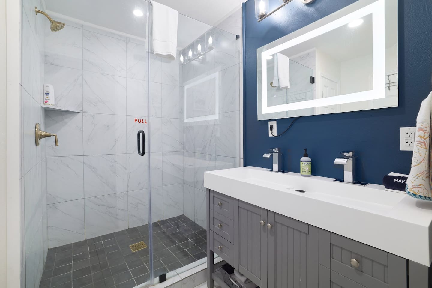 Refresh and recharge in a spa-like bathroom featuring a spacious walk-in shower, sleek finishes, and calming modern design. Clean, bright, and thoughtfully styled for a comfortable stay.