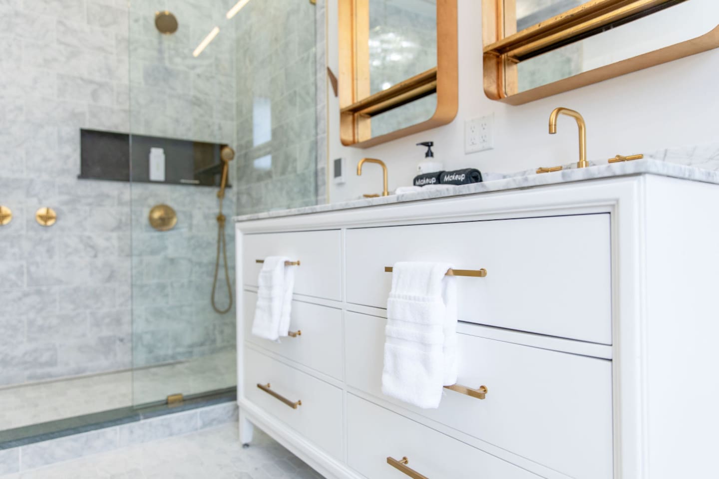 A bathroom featuring a sleek cabinet for storage, along with a modern shower area, creating a functional and stylish space for relaxation and organization.