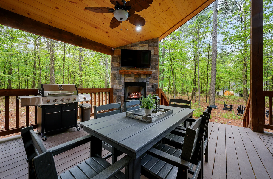 Covered outdoor dining and grilling area perfect for relaxing forest evenings