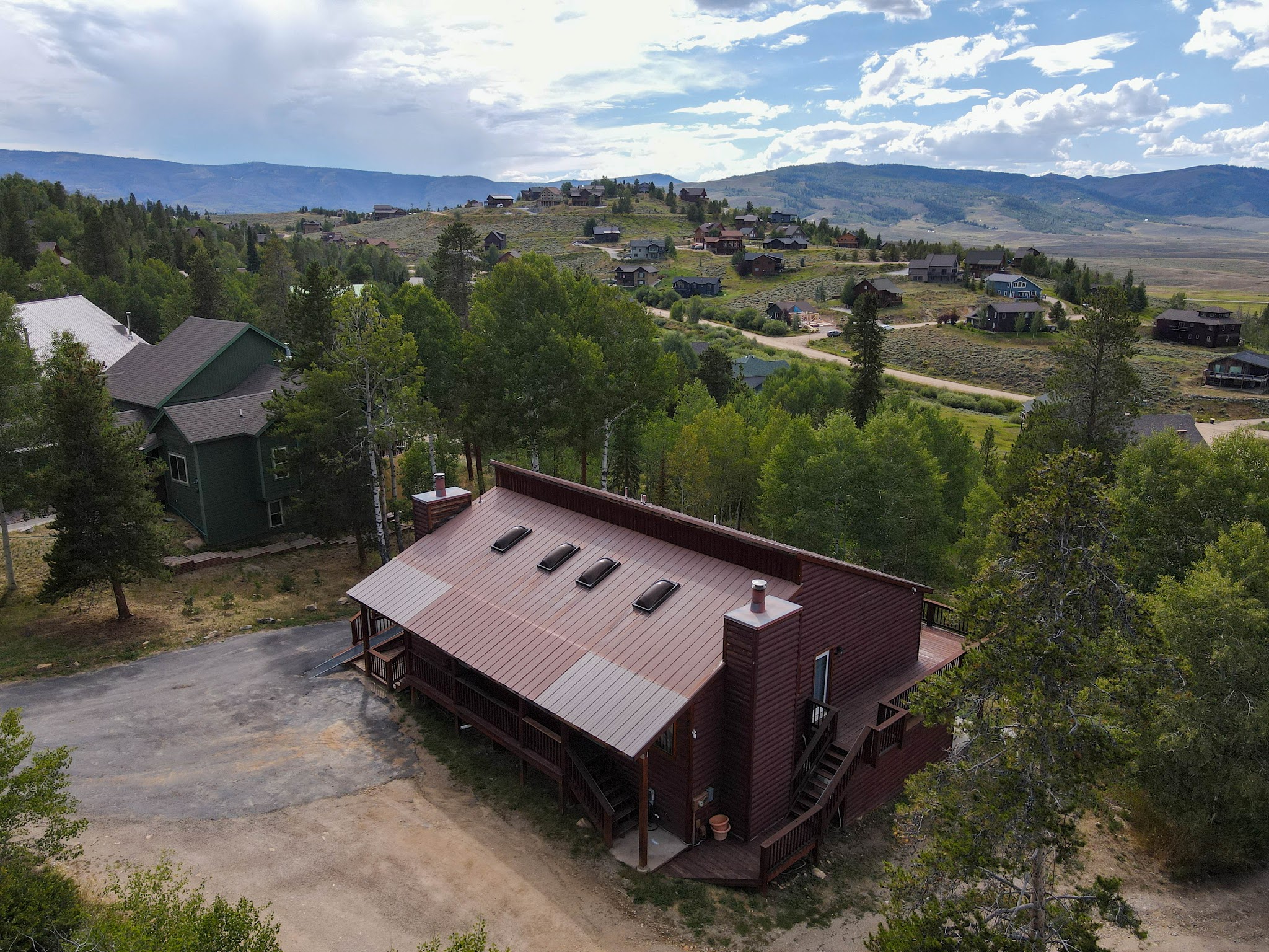 Summer aerial view of the home and mountains