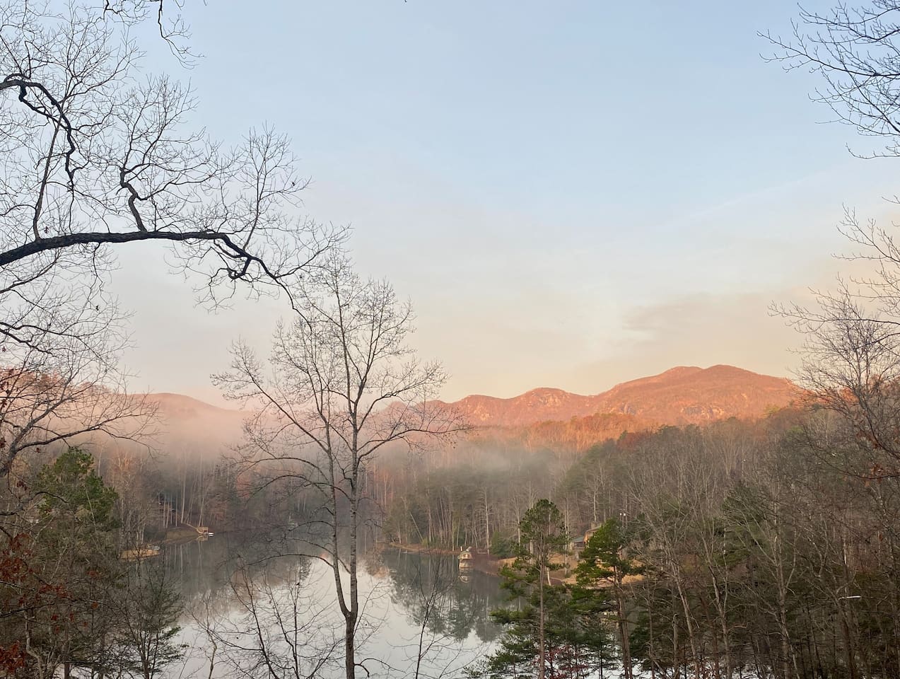 Sunrise view of Rumbling Bald mountain and lake from balcony
