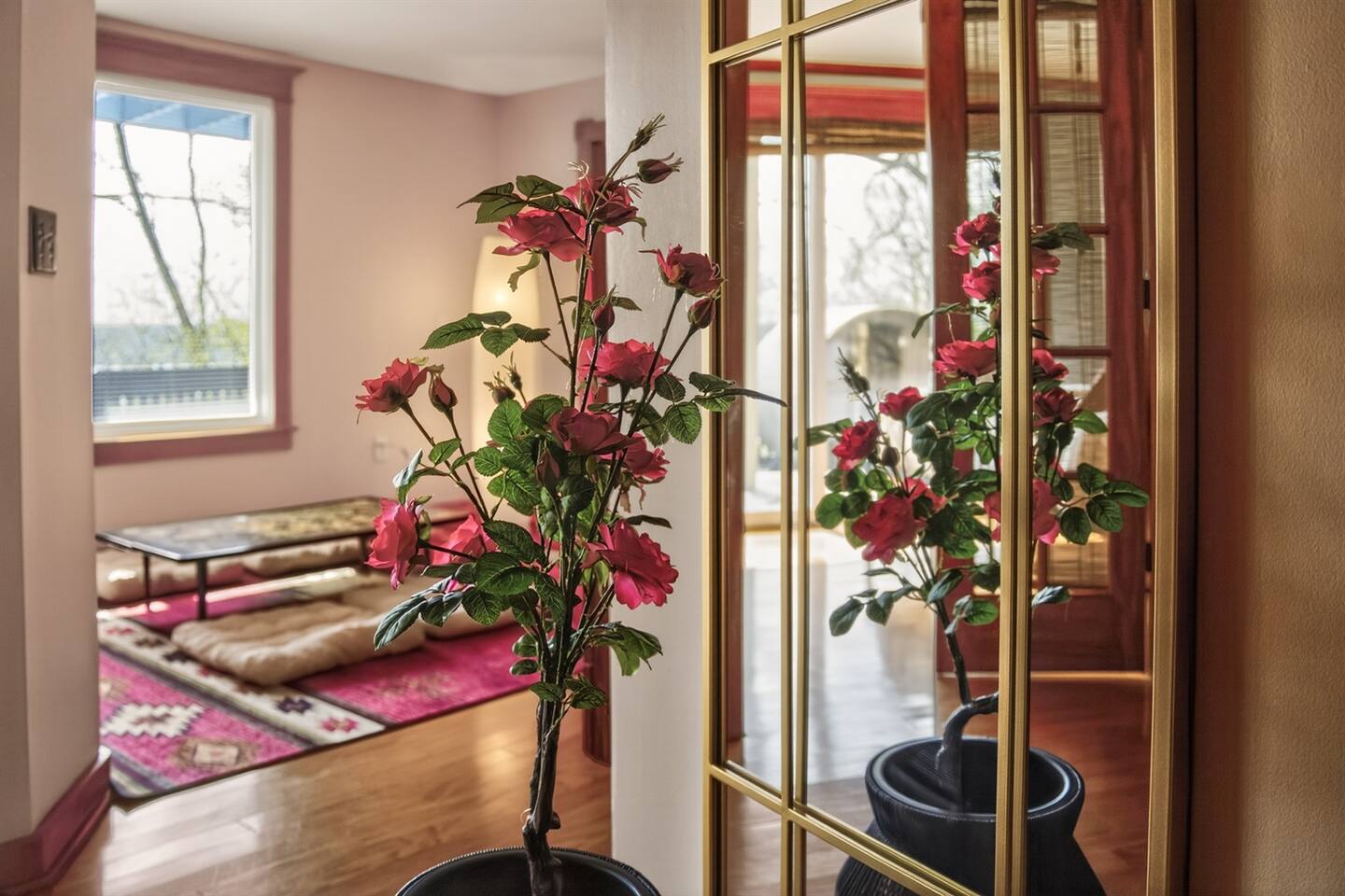 Peaceful corner with soft light and floral touches, leading into a serene Japanese-style lounge for quiet relaxation.