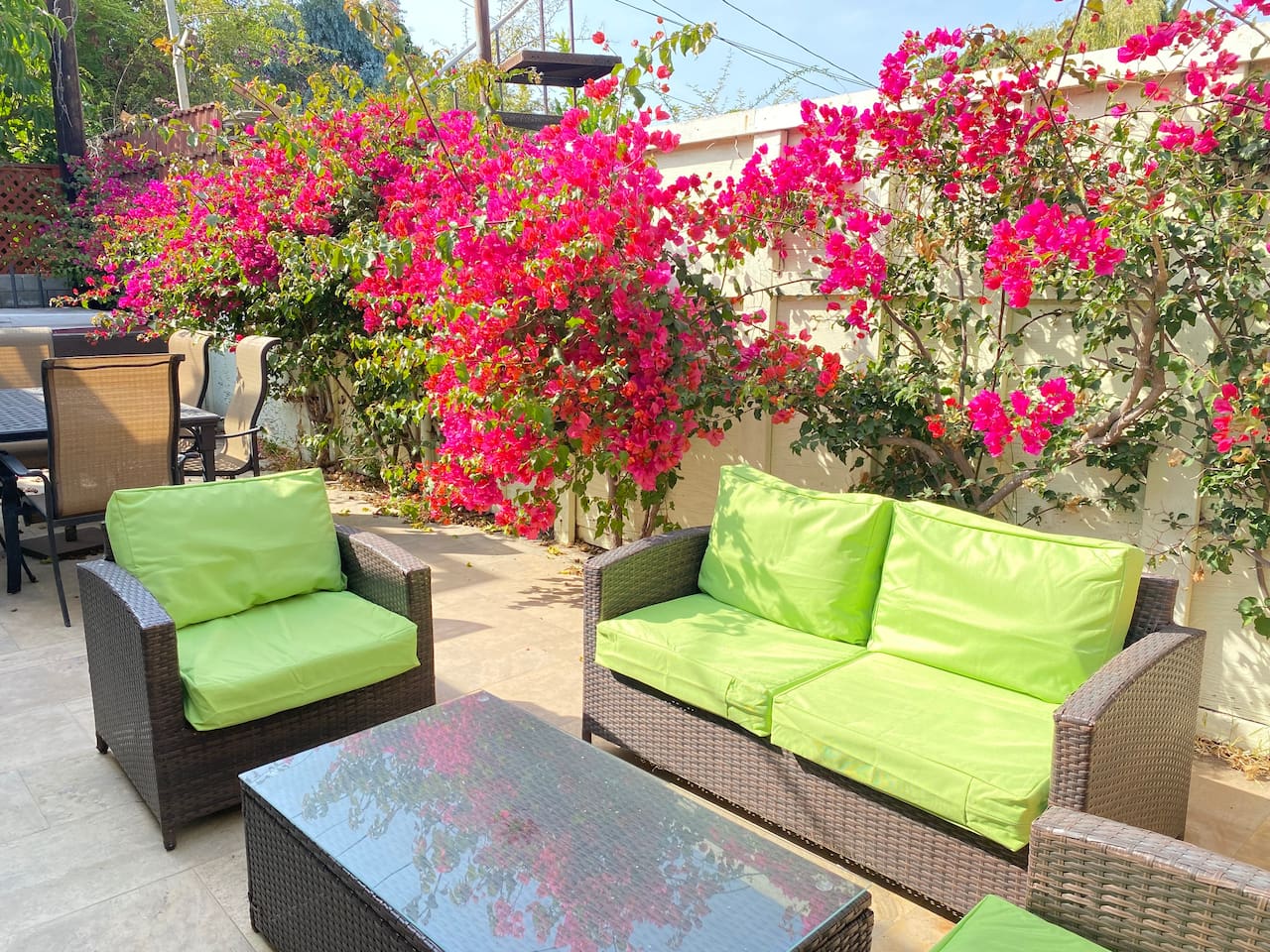 Outdoor living space with comfortable seating tucked among lush flowers.