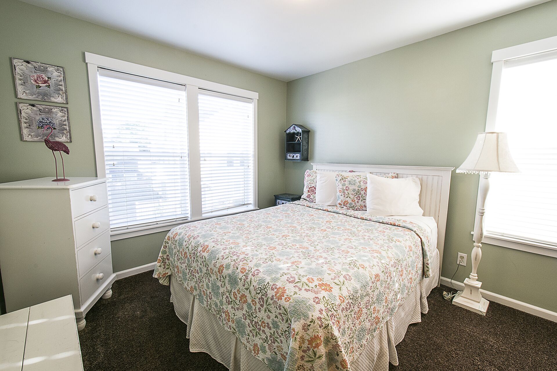 Soft pastel accents complete the queen bedroom, offering a peaceful and inviting space to unwind after a day at the beach.