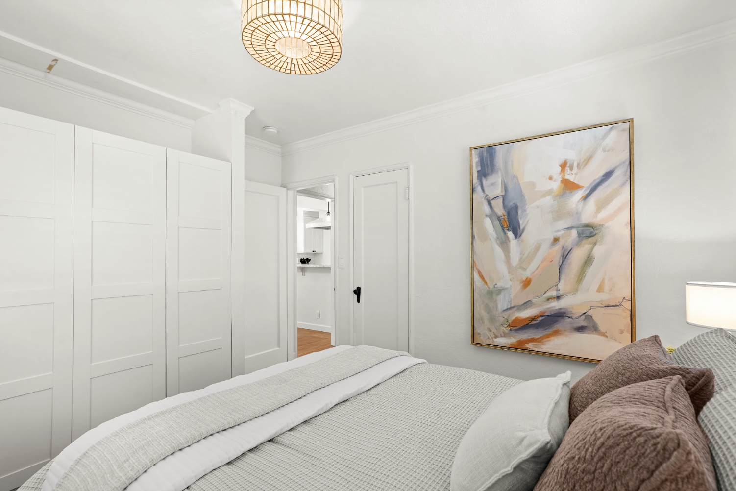 Rest easy in a serene queen bedroom filled with natural light
