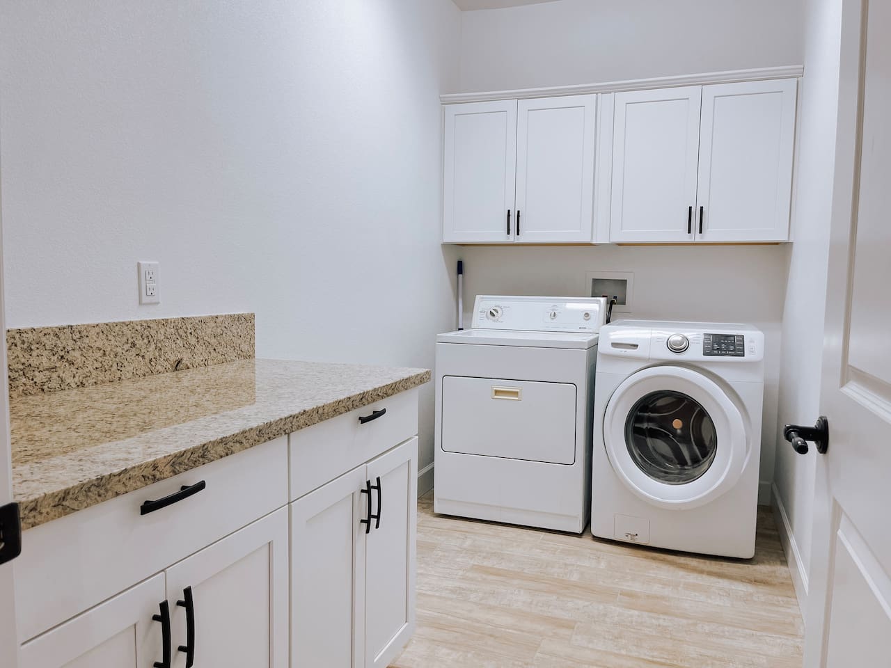 Dedicated laundry room with full size washer and dryer
