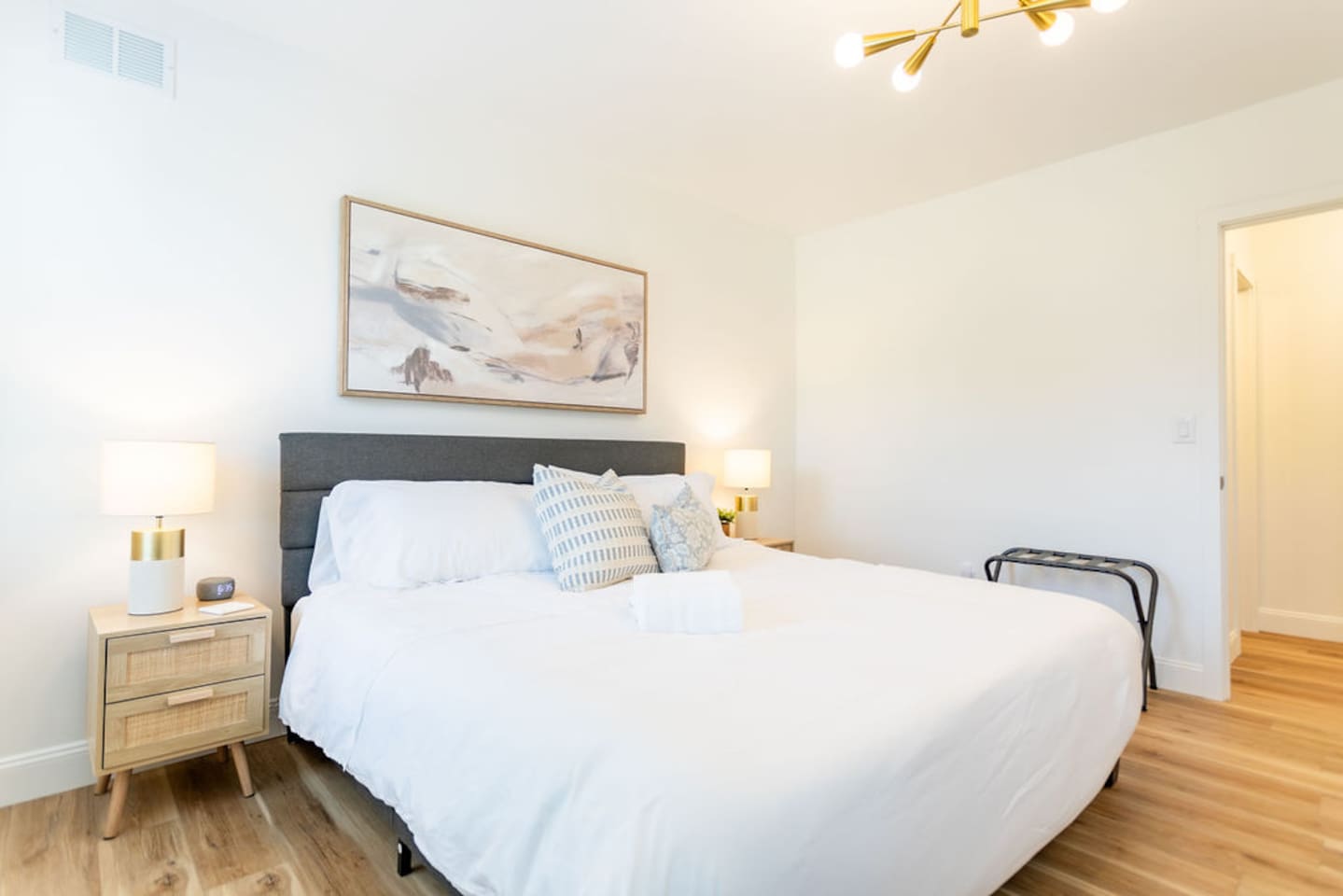 Right-side bedroom view showcasing the king-size bed with plush pillows, creating a comfortable and inviting space.
