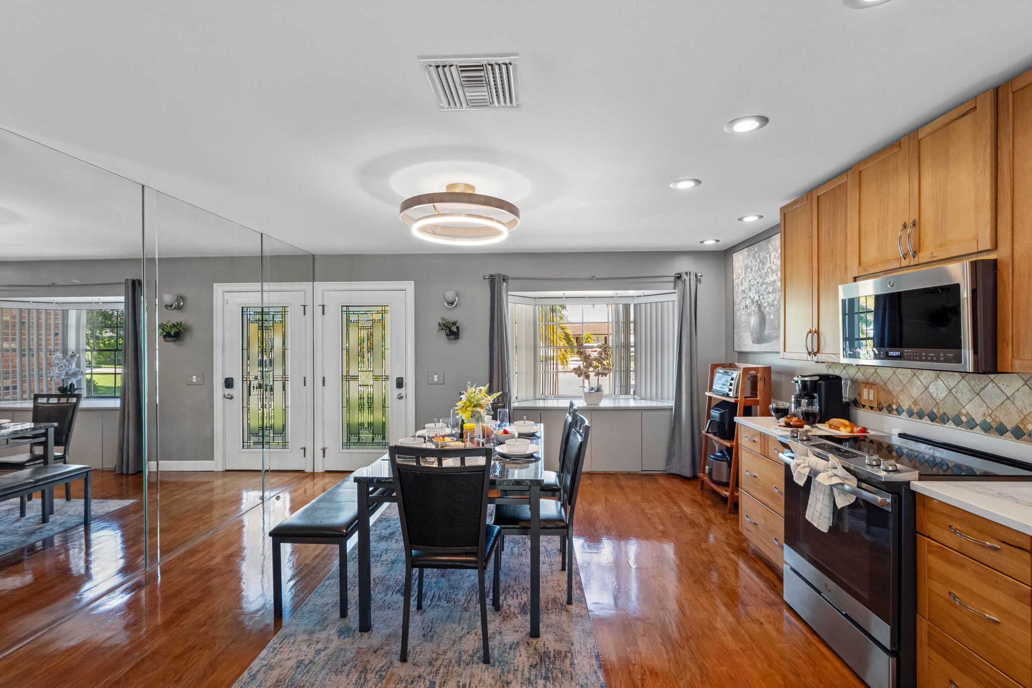This stylish dining area flows seamlessly into the kitchen and living space, creating the perfect setting for both everyday meals and special gatherings.