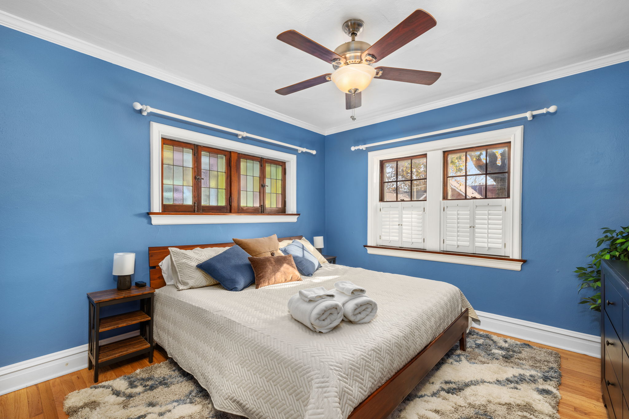 Main level bedroom 1 with King size bed with medium plush mattress, 43" flat screen smart TV, night stands and bedside lamps with USB charging stations and ceiling fan.  Dresser and closet for