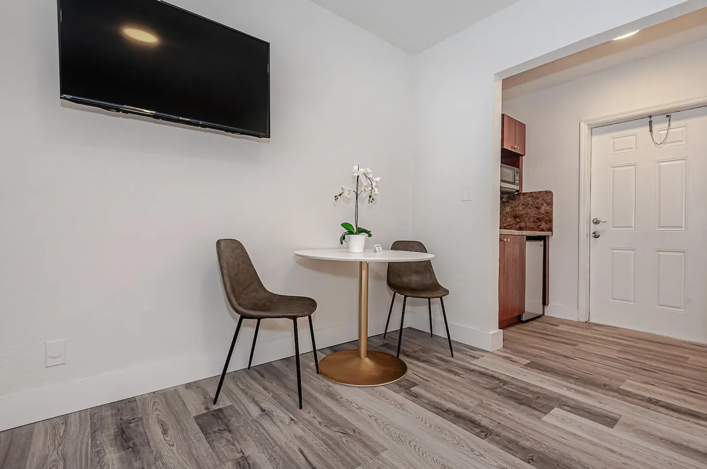 Featuring dining set and smart TV. Plush dining chairs with ottomans will be added by November 1st.