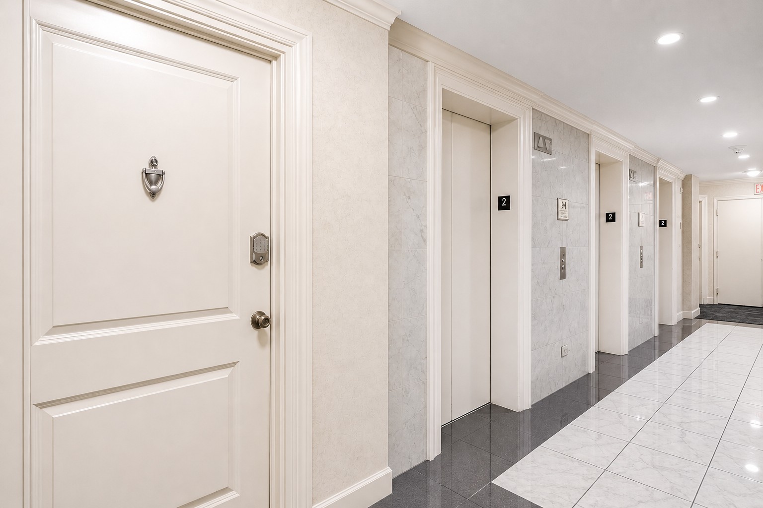 A welcoming second-floor hallway leading directly to the condo entrance.
