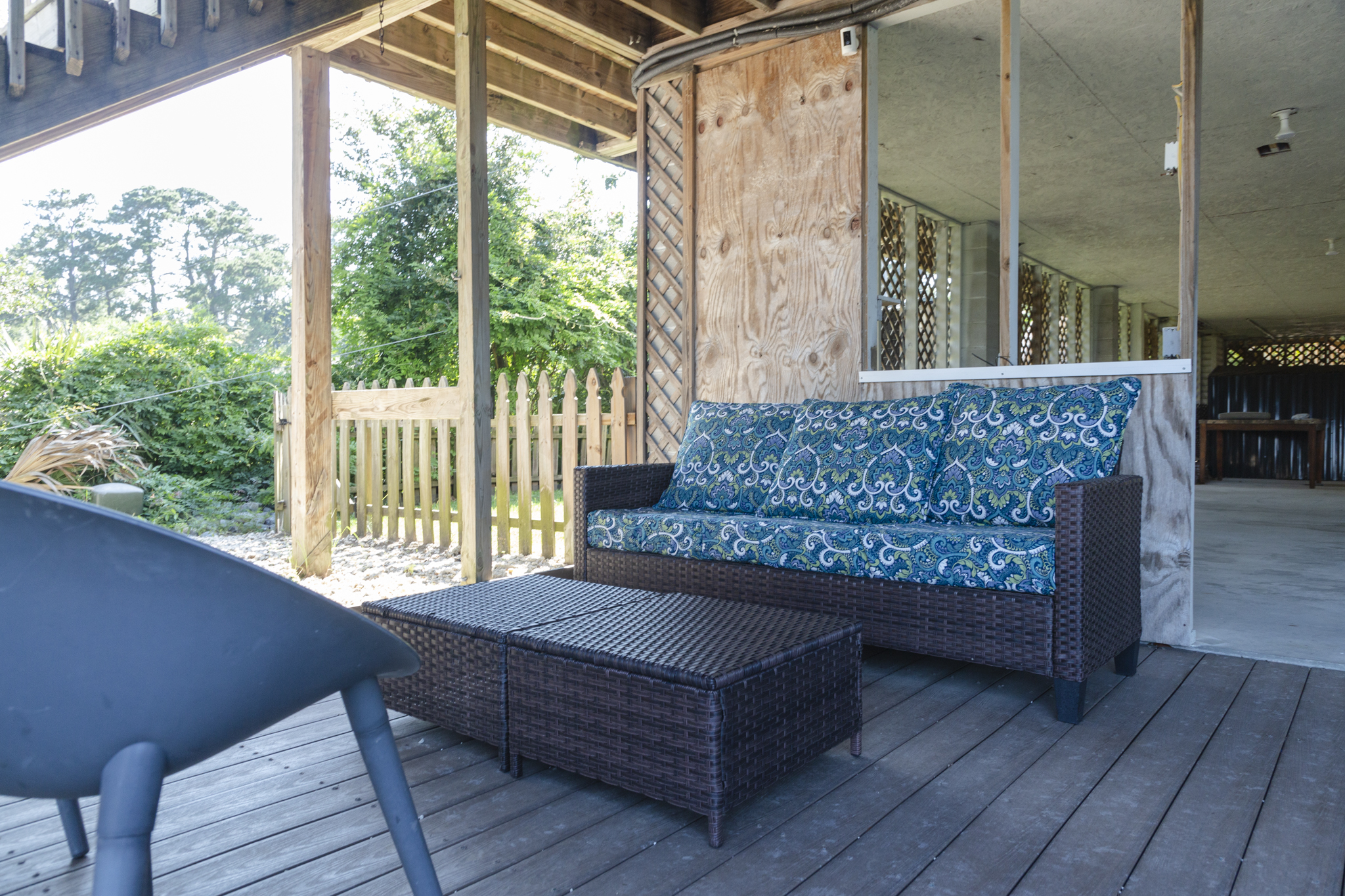 Shaded seating area beneath the home offers a cool retreat after a day in the sun.