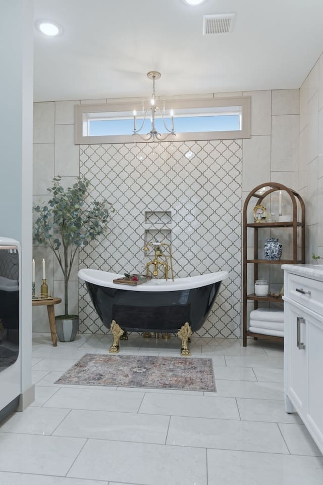 Spacious and beautifully designed bathroom with a statement clawfoot tub and elegant finishes for a relaxing, upscale feel
