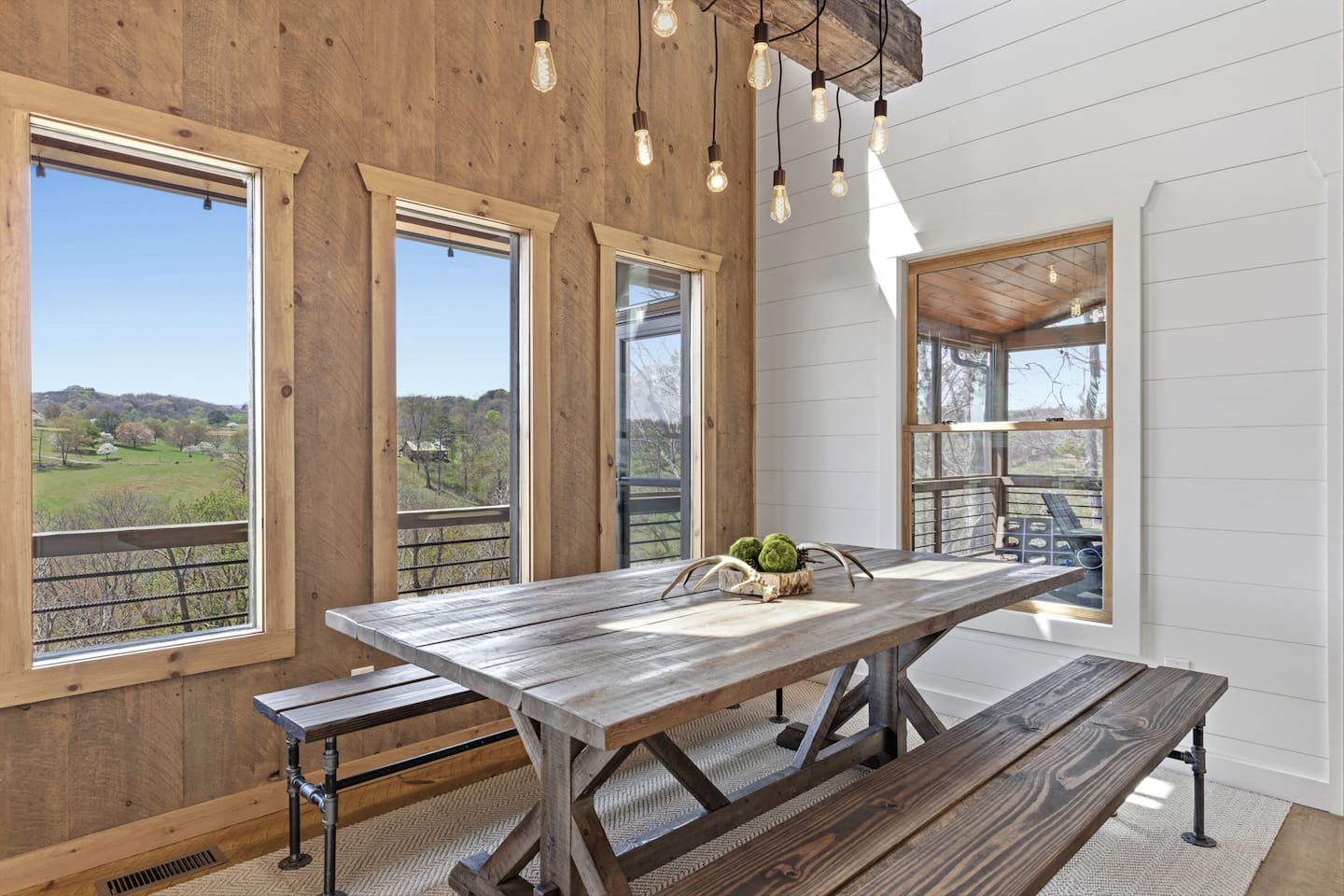 Gather around this oversized rustic farmhouse table bathed in natural light. Enjoy sweeping mountain views and watch the horses graze while dining with family and friends. The perfect spacious setting for memorable meals and connection.